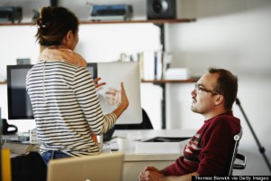 Coworkers discussing project in startup office